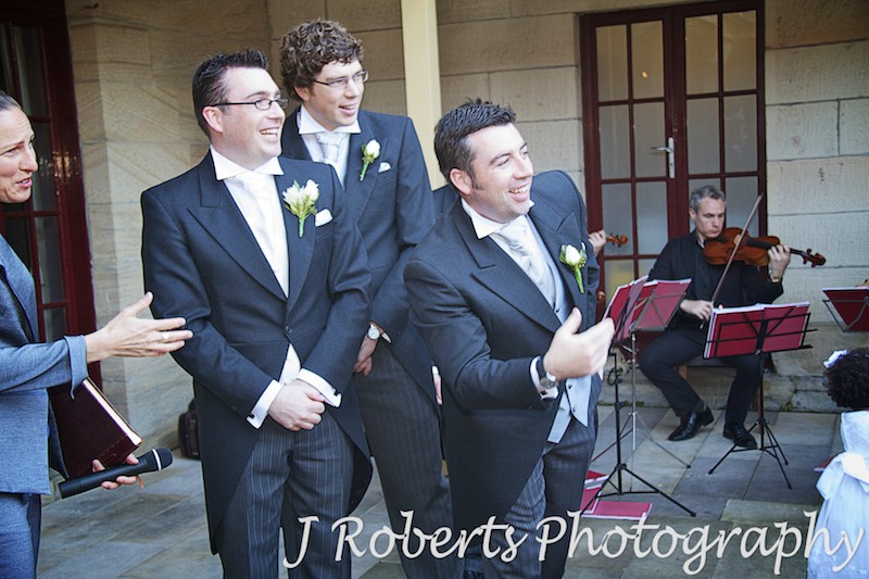 Groomsmen encouraging paige boys down the aisle - wedding photography sydney